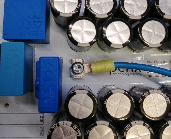 AC power terminal connection with a ring cable shoe