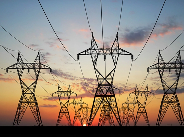 electric lines in front of sunset